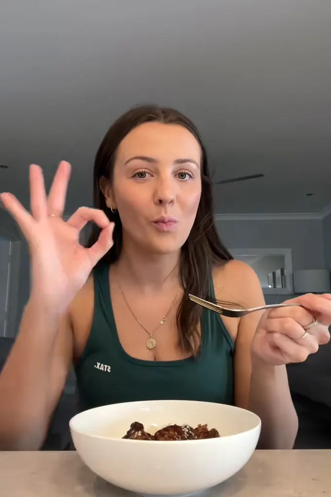 Example post, a reel: a woman eating a bowl of food and giving an OK sign